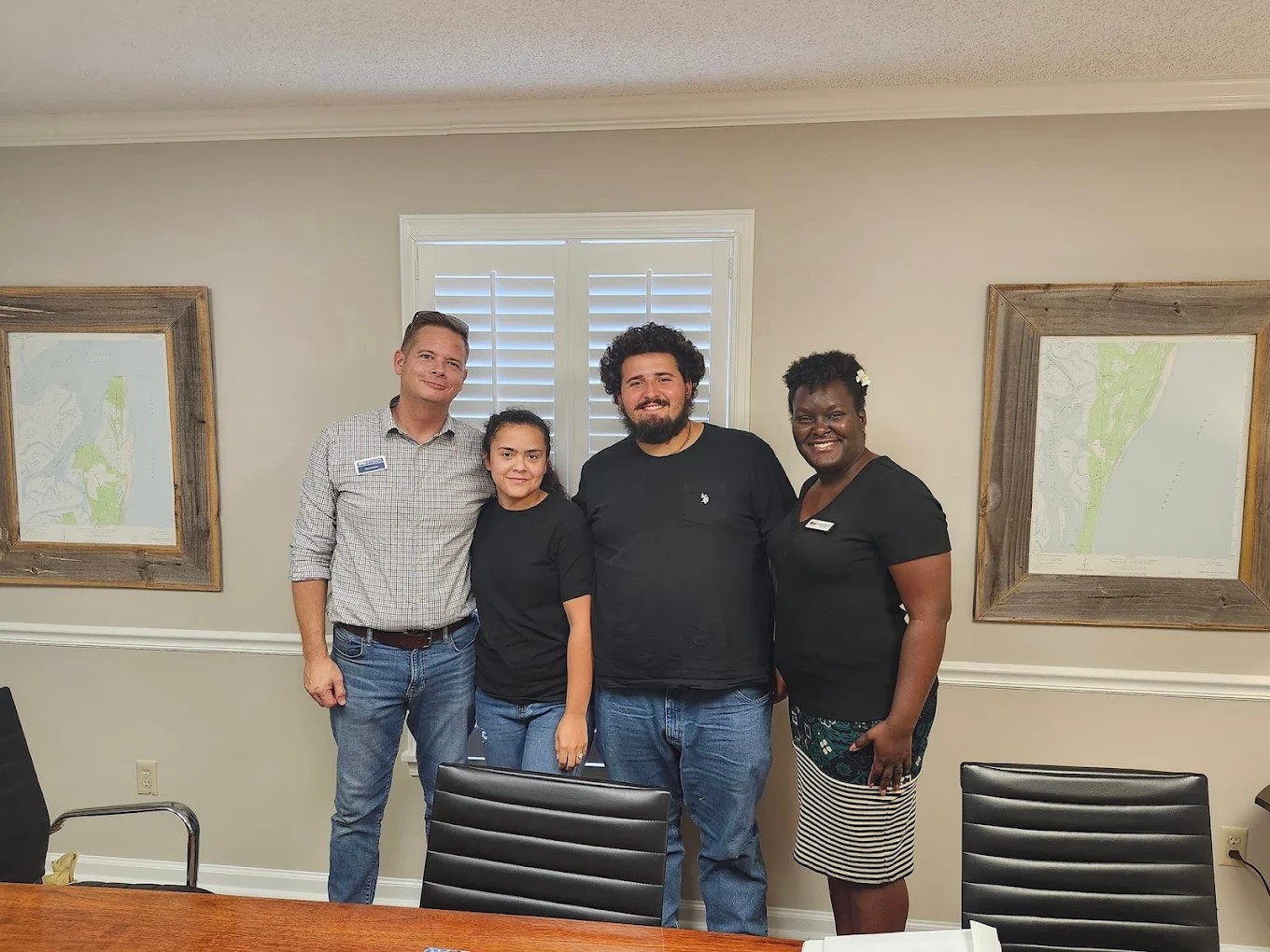 Homebuyers with real estate agent celebrating closing in Camden County