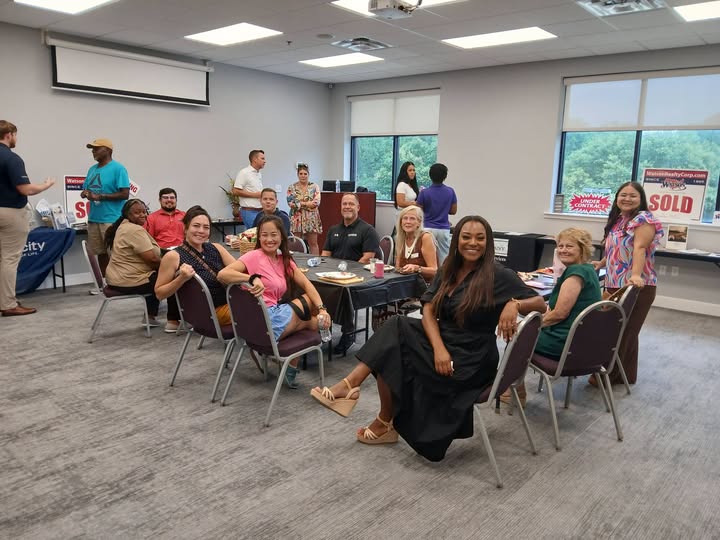 Homebuyers speaking with local professionals at a community education event